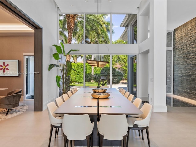 dining space featuring a towering ceiling