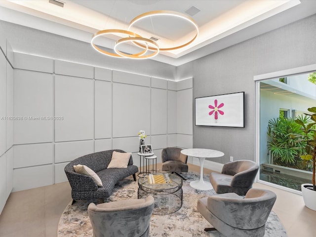 sitting room with an inviting chandelier and a high ceiling