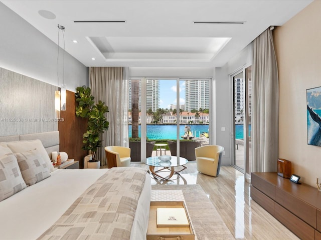 bedroom featuring a raised ceiling, light wood-style flooring, a water view, access to outside, and recessed lighting