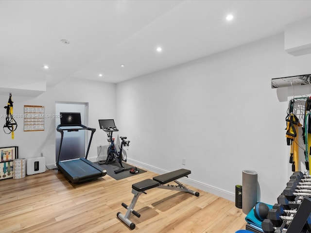 workout room with recessed lighting, baseboards, and wood finished floors