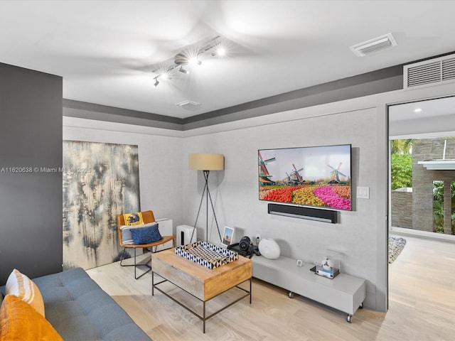 living area with light wood finished floors and visible vents