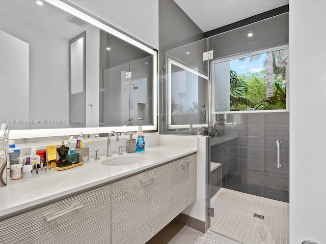 full bath with a shower stall and vanity