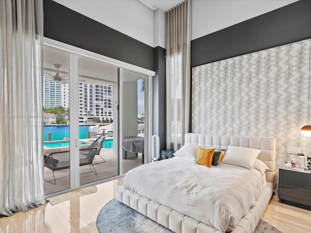 bedroom featuring wood finished floors and access to exterior