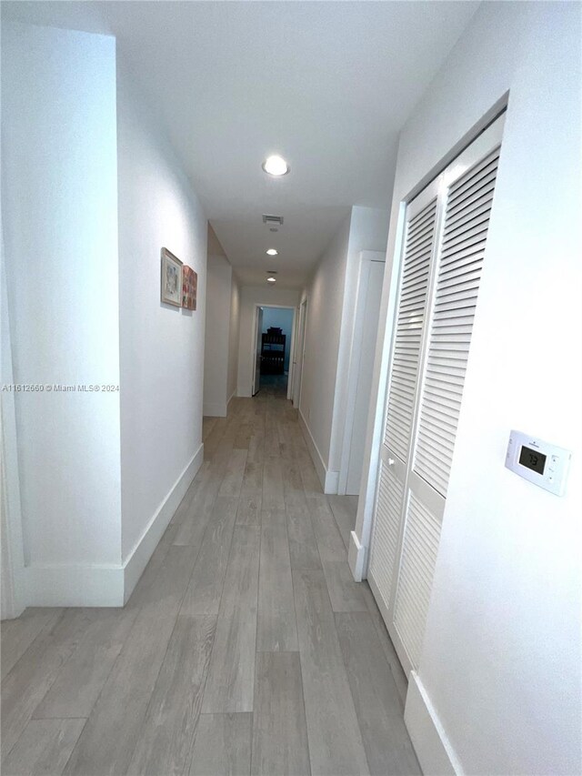 corridor with light wood-type flooring