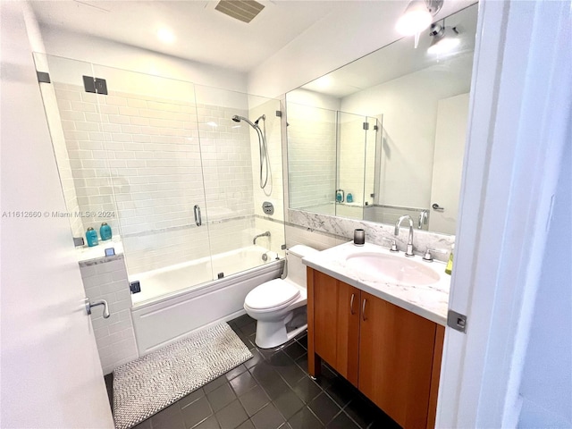 full bathroom with toilet, bath / shower combo with glass door, tile patterned floors, and vanity