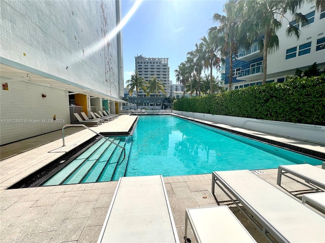 view of swimming pool with a patio area