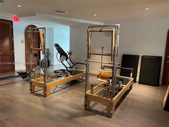 workout room with light hardwood / wood-style floors