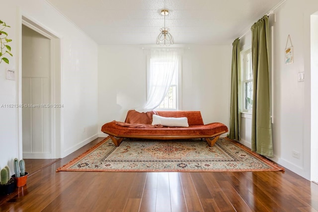 sitting room featuring hardwood / wood-style flooring and crown molding