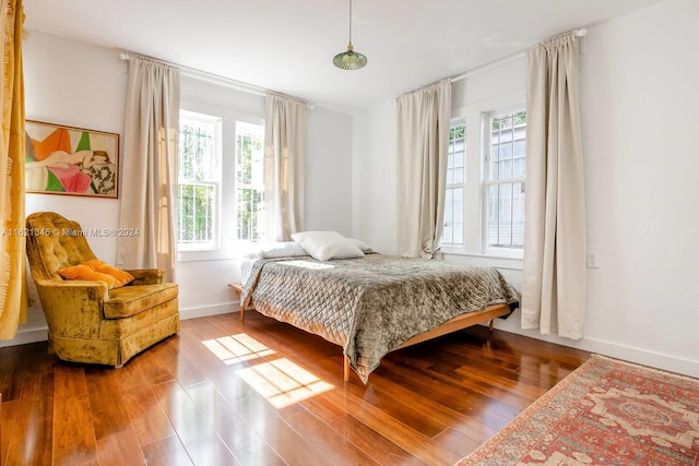 bedroom featuring multiple windows and hardwood / wood-style floors