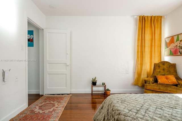 bedroom with dark wood-type flooring