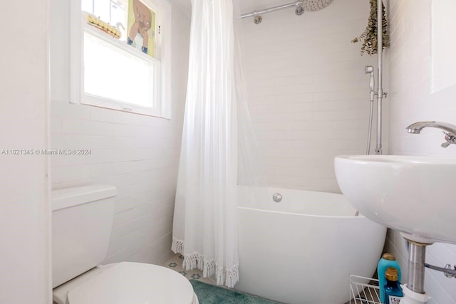 bathroom featuring shower / tub combo, tile walls, and toilet