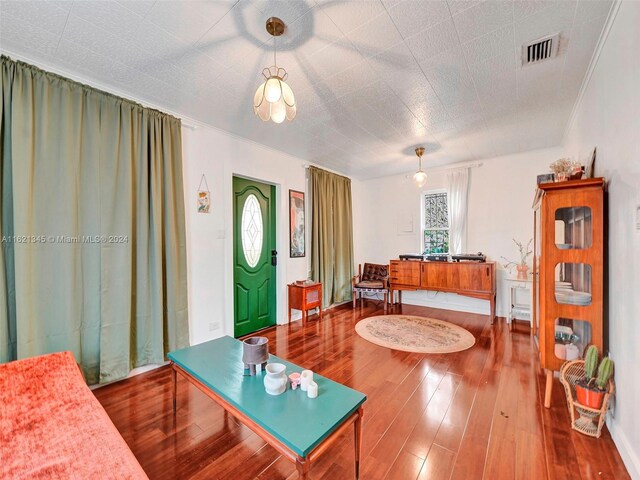 living room featuring crown molding and wood-type flooring