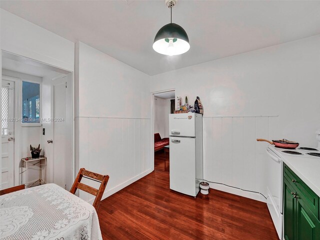 bedroom with wood-type flooring and white refrigerator