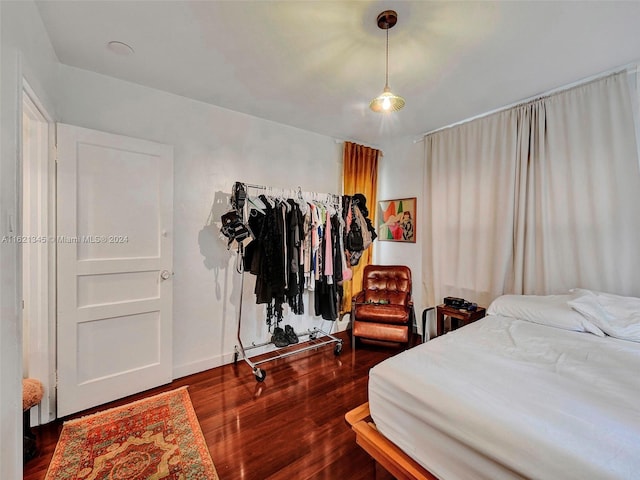 bedroom with dark hardwood / wood-style floors