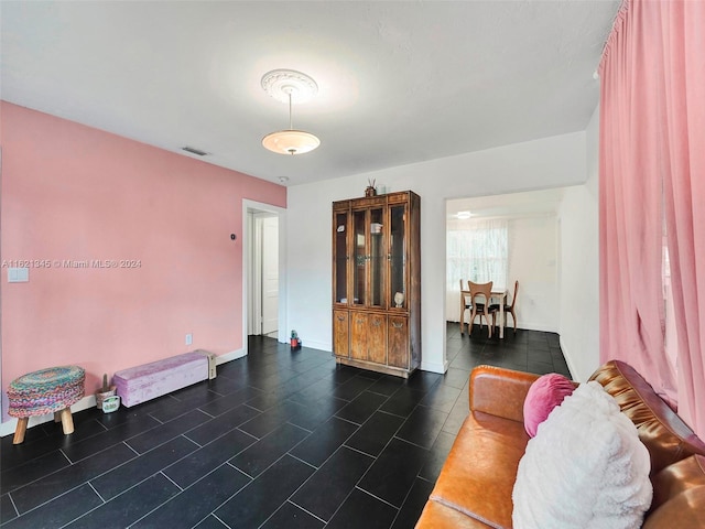 living room featuring dark tile patterned floors