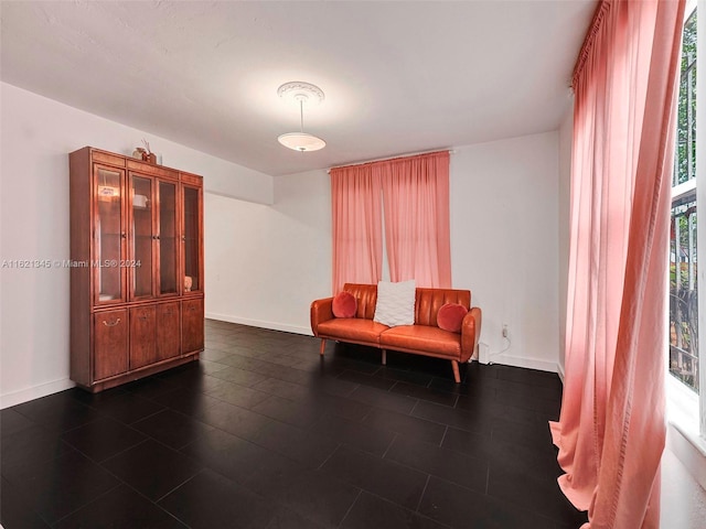 sitting room featuring dark tile patterned floors