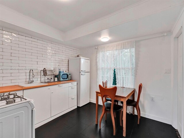 dining room featuring crown molding and sink