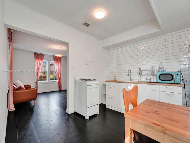 kitchen featuring wooden counters, a raised ceiling, crown molding, white cabinets, and white gas range oven