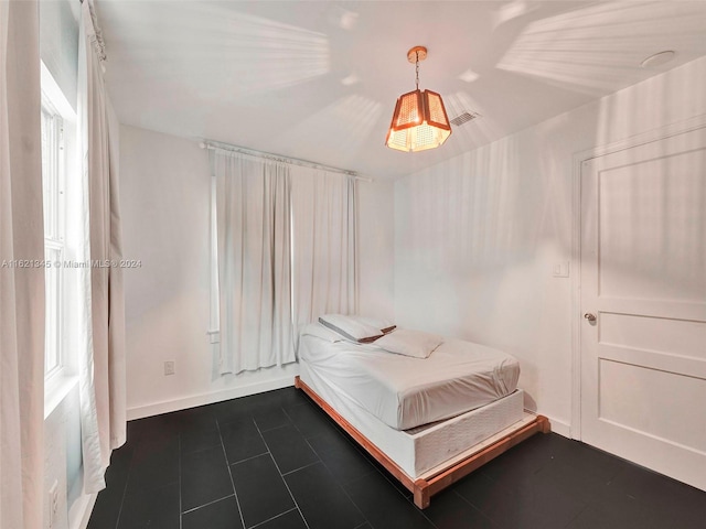 unfurnished bedroom featuring dark tile patterned floors