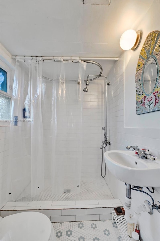 bathroom featuring toilet, tile patterned floors, and a shower with shower curtain