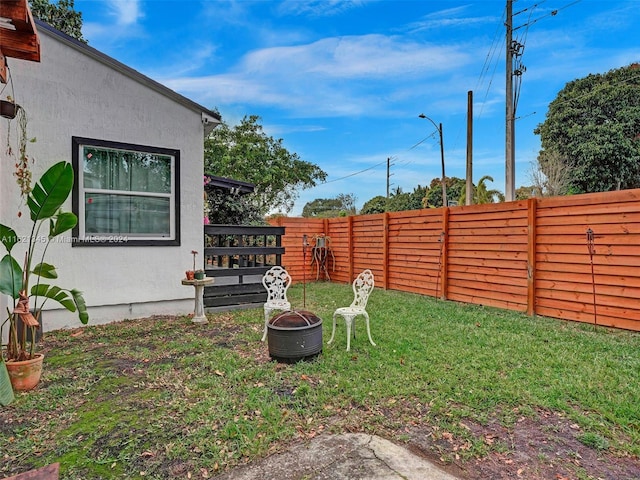 view of yard with a fire pit