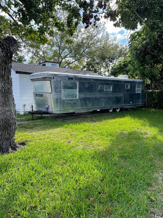 back of property featuring a lawn