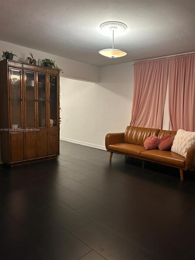 unfurnished room featuring dark tile patterned flooring