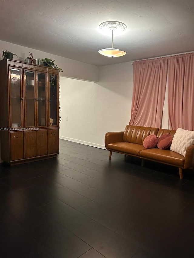 unfurnished room with dark tile patterned floors