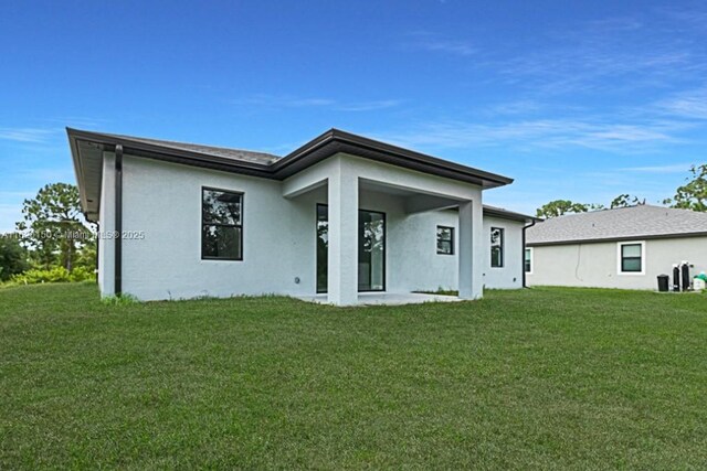 rear view of house with a yard