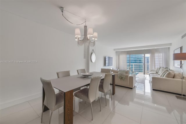 tiled dining space featuring an inviting chandelier