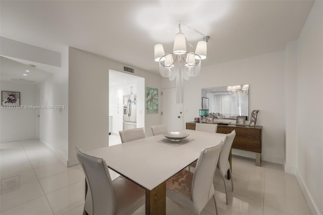 dining space with a notable chandelier and light tile patterned floors