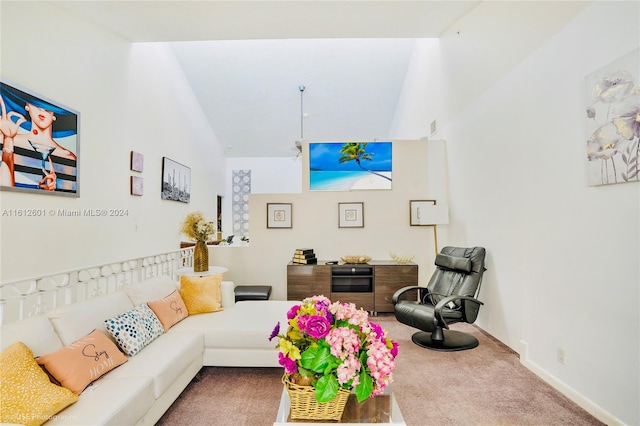 carpeted living room with lofted ceiling