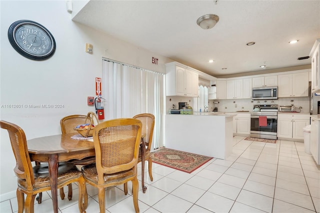 tiled dining room with sink