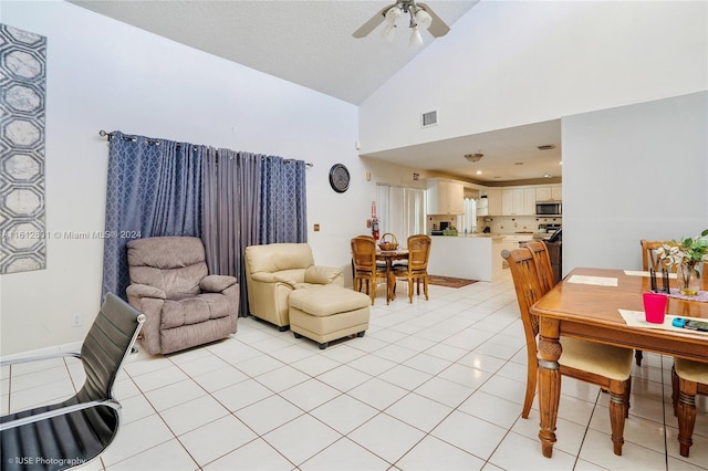 tiled living room featuring high vaulted ceiling and ceiling fan