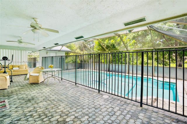 view of pool with a lanai, a patio area, and ceiling fan