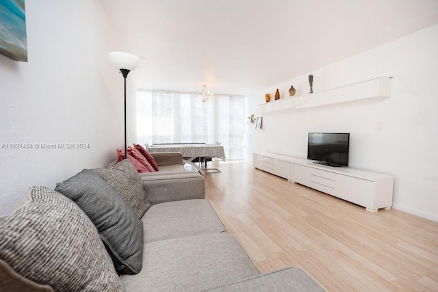 living room featuring light hardwood / wood-style flooring and a chandelier