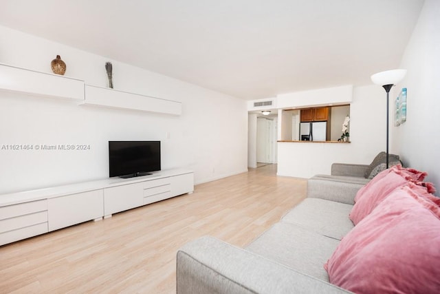 living room with light wood-style flooring and visible vents