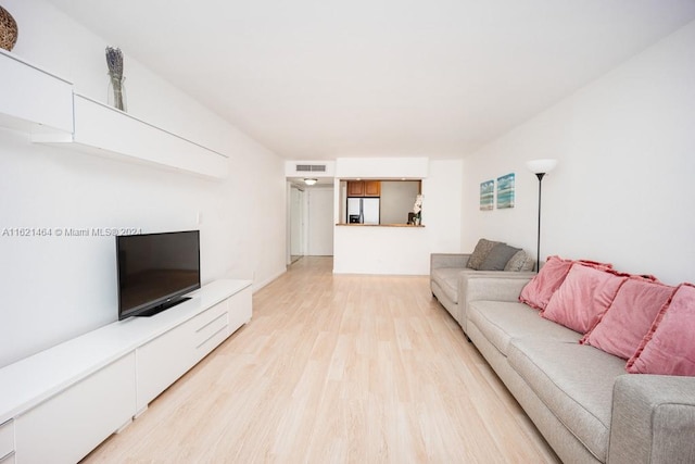 living room with visible vents and light wood-style floors