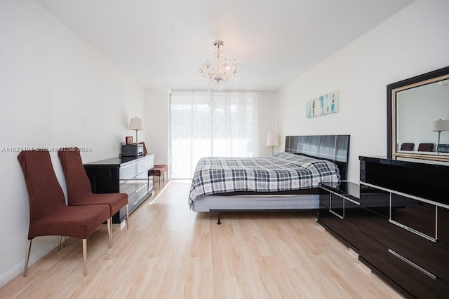 bedroom featuring a notable chandelier and wood finished floors