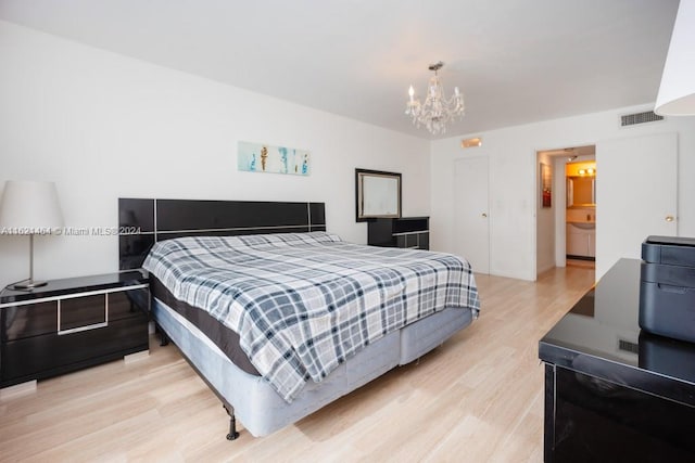 bedroom featuring a notable chandelier, visible vents, and light wood-style floors