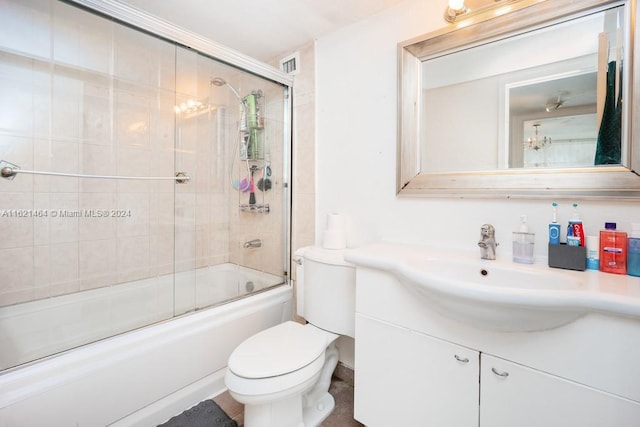 full bathroom with visible vents, bath / shower combo with glass door, vanity, and toilet