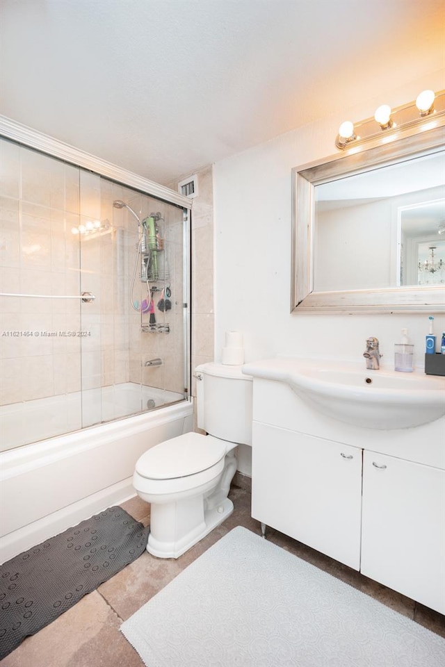 full bathroom featuring toilet, combined bath / shower with glass door, visible vents, and vanity