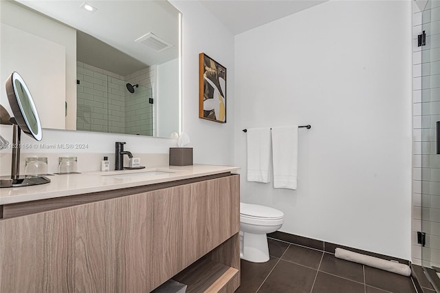 bathroom with vanity, tile patterned flooring, and toilet