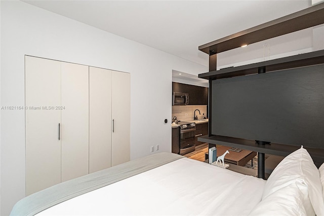 bedroom featuring sink and hardwood / wood-style flooring