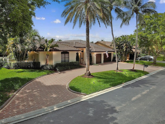 mediterranean / spanish-style house with a front lawn and a garage