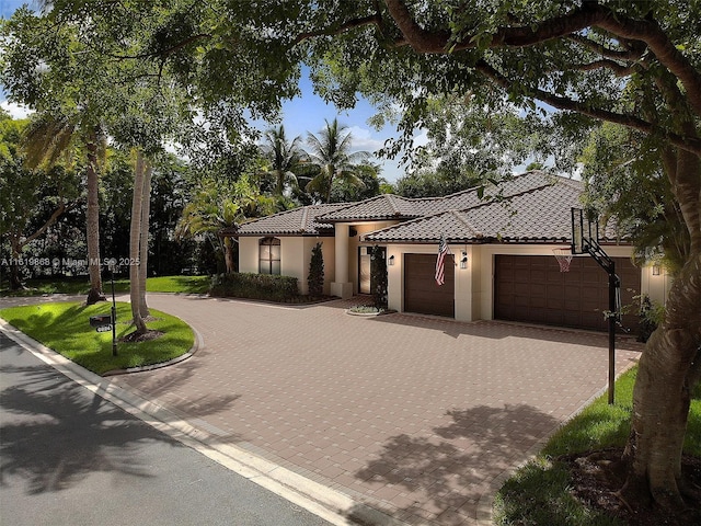 mediterranean / spanish house with a garage