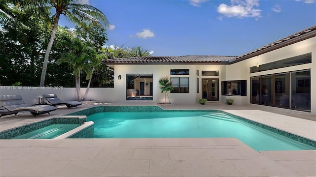 view of swimming pool featuring an in ground hot tub and a patio