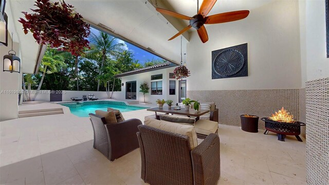 view of swimming pool featuring a fire pit and a patio area