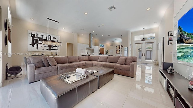 tiled living room with a towering ceiling