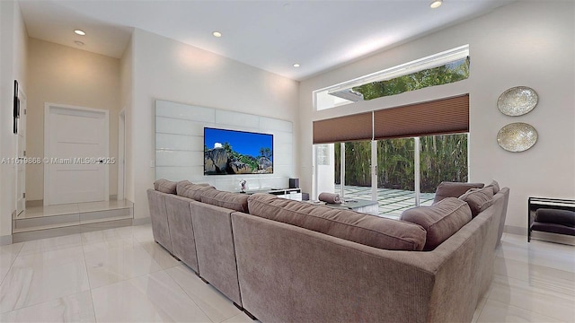 living room featuring light tile patterned flooring and a high ceiling